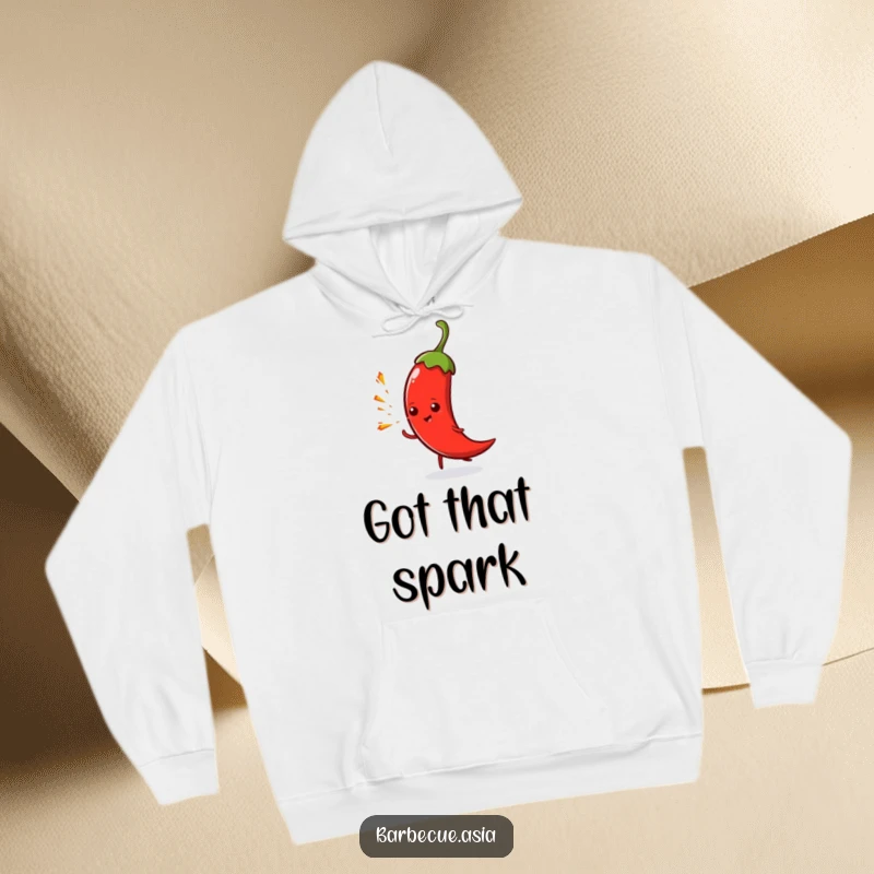 Funny spicy chili pepper character spitting tiny sparks, featured on a warm and cozy hoodie.